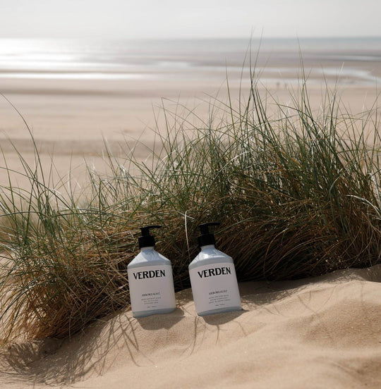 Arborealist Hand and Body Balm and Hand and Body Wash on sand