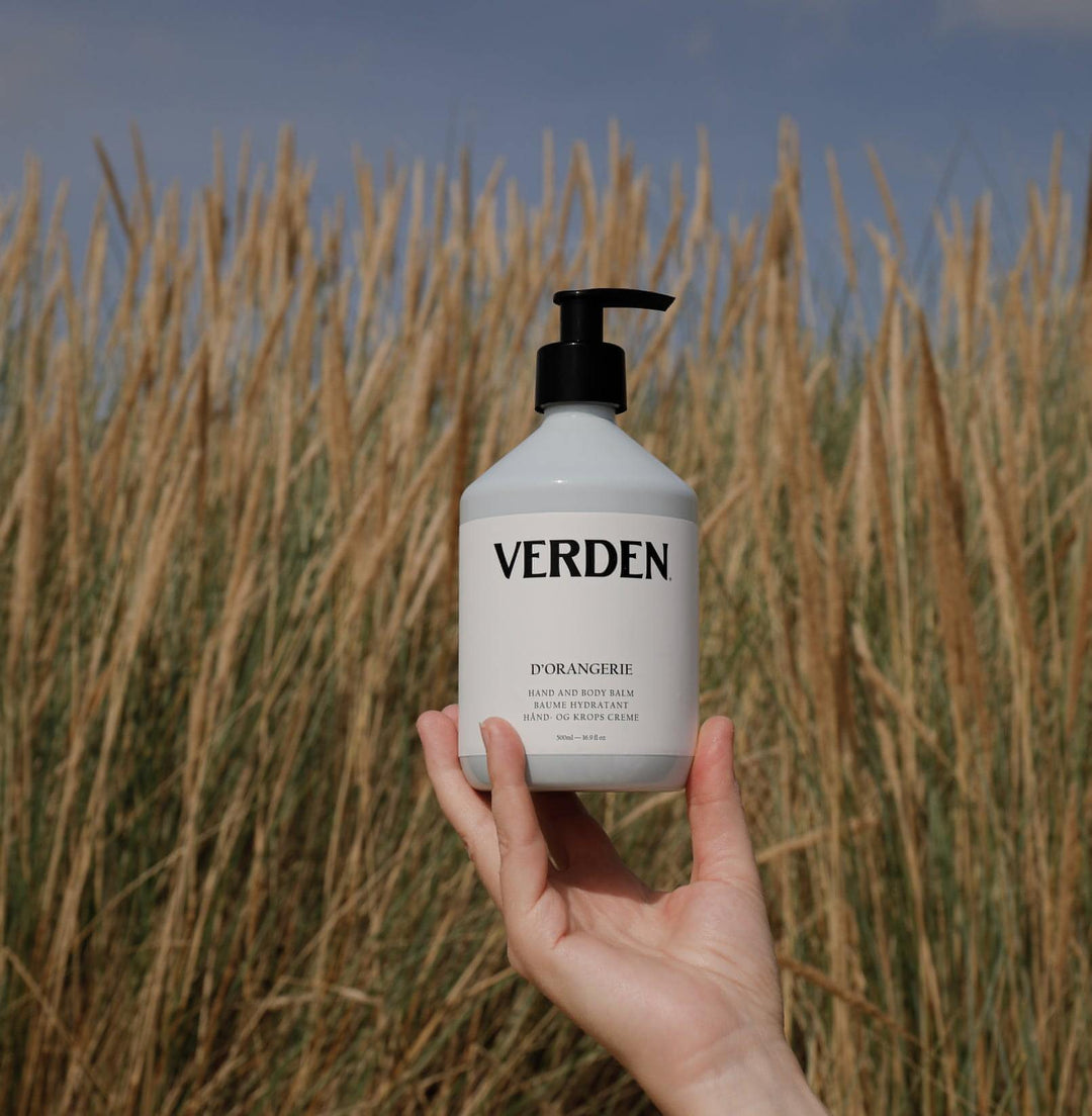 D'Orangerie Hand and Body Balm held above grass