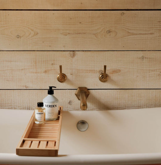Herbanum Bath Oil and Hand and Body Wash on bath shelf