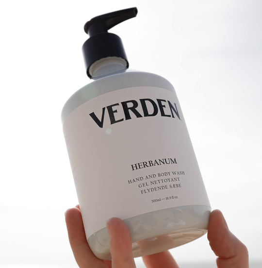 Herbanum Hand and Body Wash held in sky